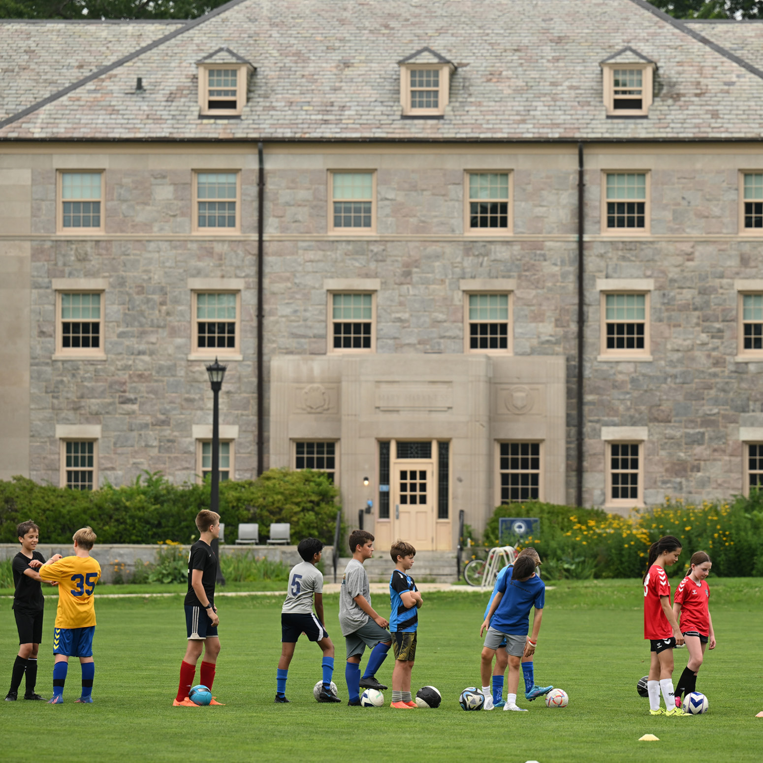 kids at soccer camp on the green