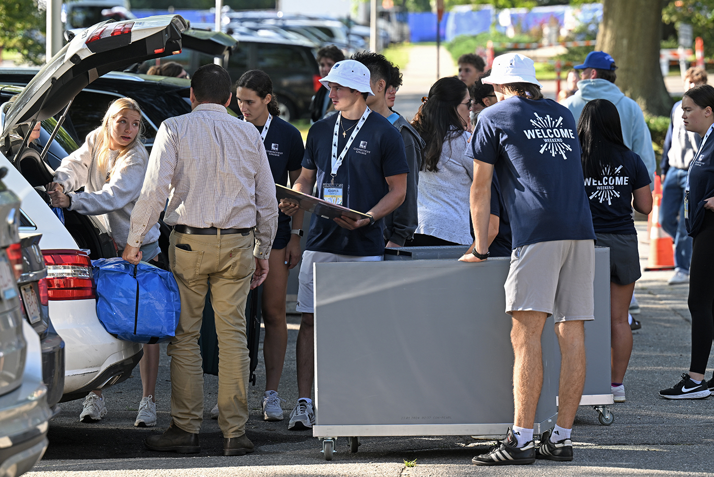 Students and their families unload cars during campus move-in day.